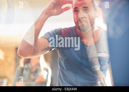 Mid adult man looking in shop window Stock Photo