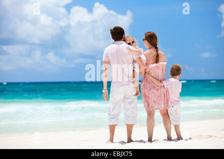 family with two children admiring the view on Caribbean beach, Mexico