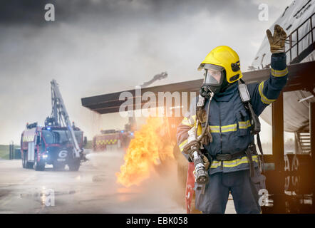 Portrait of fireman in front of simulated fire at airport training facility