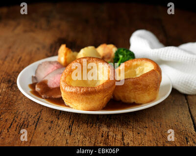 Plate of roast beef, yorkshire puddings, broccoli and potatoes Stock Photo