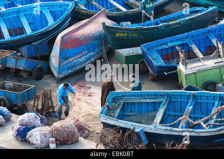 fishermen with fishing boats in the harbour, Morocco, Essaouira Stock Photo