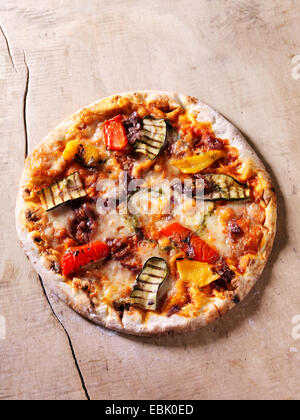 Italian chargrilled pizza with courgettes, peppers, onions, tomatoes and cheese Stock Photo