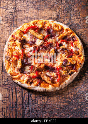 Italian spicy chicken pizza with red chillies, red onion and mozzarella Stock Photo