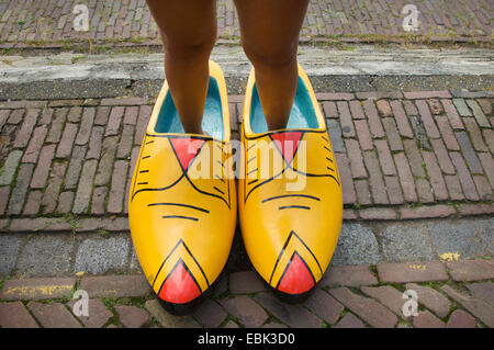 Woman wearing very big wooden shoes in the Netherlands Stock Photo