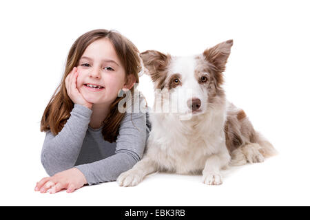 little girl with a border collie in front of a white background Stock Photo