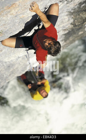 two climbers on steep rock face Stock Photo
