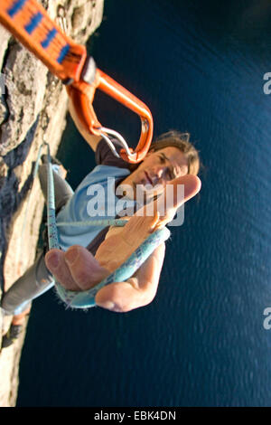 climber clip the rope to carabiner, Italy, Lake Garda Stock Photo