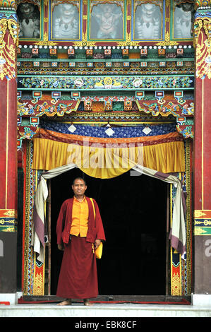 monk at an entrance of  the stupa of Bouddhanath, one of the holiest Buddhist sites of the country, Nepal, Bodnath, Kathmandu Stock Photo