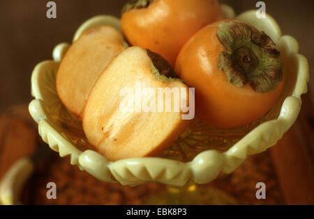 kaki plum tree, Japanese persimmon (Diospyros kaki), kakis in a basket Stock Photo