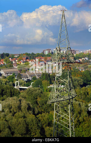 power pole in front over forest and housing area in the Ruhr valley near Essen, Germany, North Rhine-Westphalia, Ruhr Area, Essen Stock Photo