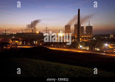 view from Angerpark stockpile to Huettenwerke Krupp Mannesmann in evening light, Germany, North Rhine-Westphalia, Ruhr Area, Duisburg Stock Photo