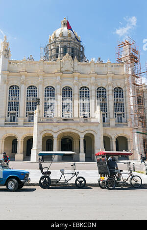 HAVANA - MAY 5: Ride tricycles in front of the Museum of Revolution May 5,2014 in Havana.Thousands of these tricycles-taxi are i Stock Photo