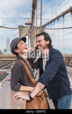 USA, New York State, New York City, Brooklyn, Happy couple flirting on Brooklyn Bridge Stock Photo