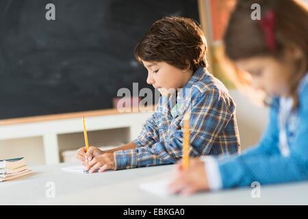 Pupils (6-7) learning in classroom Stock Photo