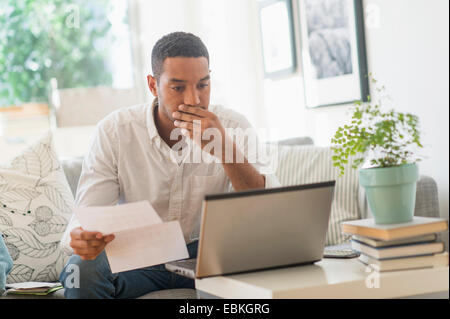 Man paying bills online Stock Photo