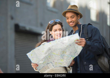 Couple reading map on street Stock Photo