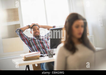 Businessman relaxing in office Stock Photo