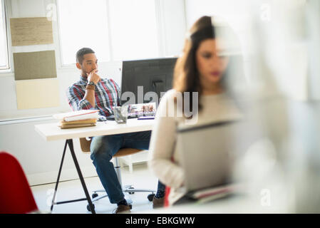 Businessman concentrating in office Stock Photo