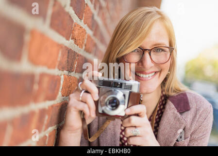 Woman holding vintage camera Stock Photo