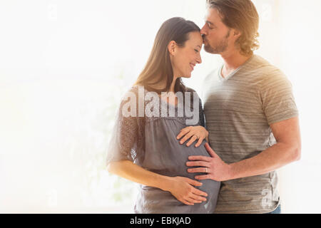 Man kissing pregnant woman Stock Photo