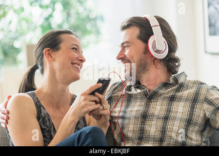 Cheerful couple listening to music at home Stock Photo