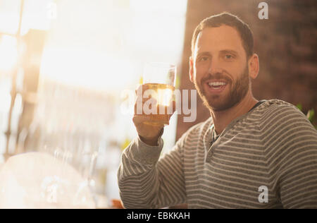 Portrait of man having drink in bar Stock Photo