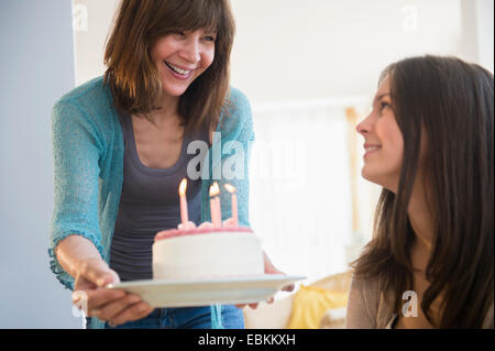 Teenage girl (14-15) celebrating birthday with her mom at home Stock Photo