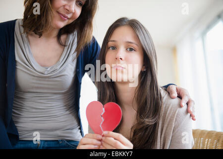 Mom comforting her heartbroken teenage daughter (14-15) Stock Photo