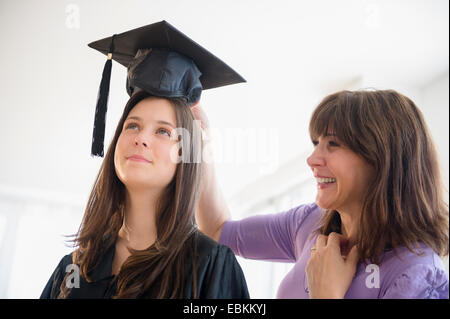 Teenage girl (14-15) getting ready for graduation ceremony Stock Photo