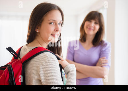 Portrait of teenage student (14-15) , mother in background Stock Photo