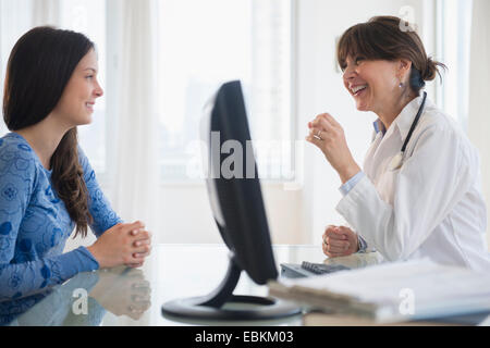 Doctor talking with teenage patient (14-15) Stock Photo
