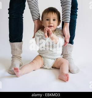 Portrait of cute baby girl (12-17 months) with her mom Stock Photo