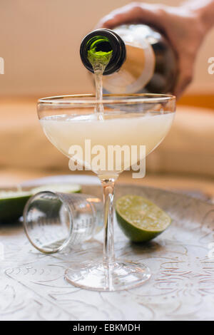 Woman mixing champagne with cocktail Stock Photo