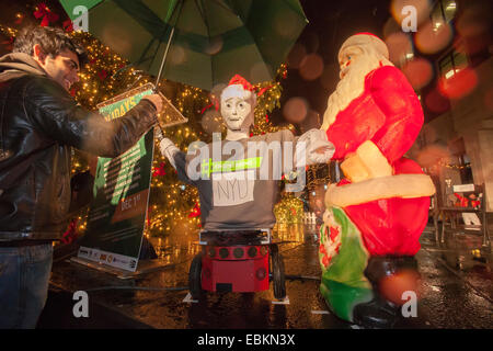 Caesar the robot pushes the switch to light the MetroTech Christmas tree at their 25th annual tree lighting in Brooklyn Stock Photo