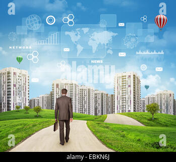 Businessman walking along road running through green hills towards city . Charts, rectangles, diagrams and other virtual items in sky Stock Photo