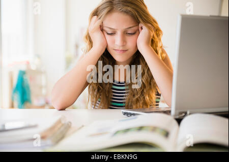 Girl (12-13) doing homework Stock Photo