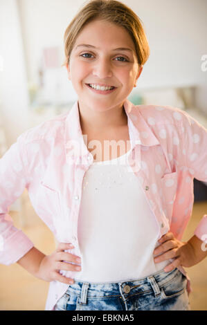Portrait of girl (12-13) with arms akimbo Stock Photo
