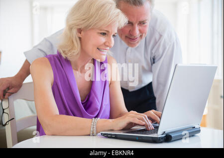 Portrait of couple looking at laptop screen Stock Photo