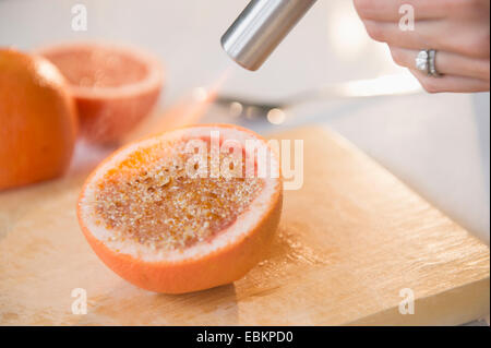 Studio shot of caramelizing sugar on grapefruit slice Stock Photo