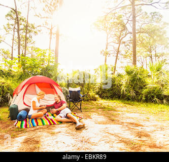 USA, Florida, Tequesta, Couple playing cards in front of tent Stock Photo