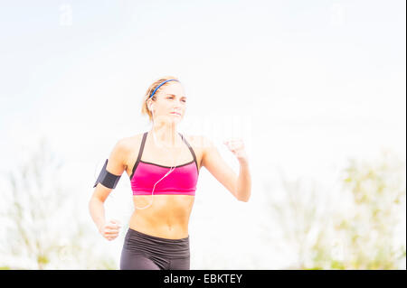 Young woman jogging in park Stock Photo