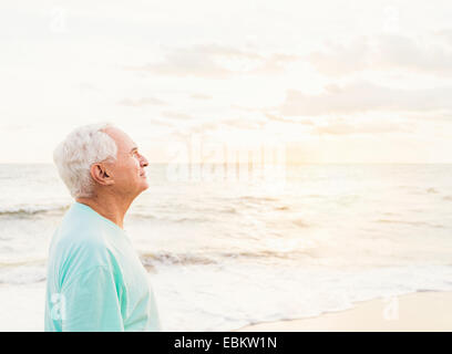 USA, Florida, Jupiter, Side view of senior man smiling on beach Stock Photo