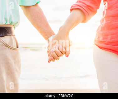 USA, Florida, Jupiter, Couple holding hands on beach Stock Photo