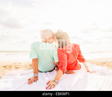 USA, Florida, Jupiter, Rear view of couple kissing on beach at sunrise Stock Photo