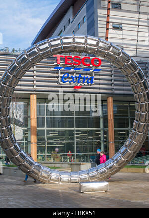 Tesco Extra store sign seen through stainless steel Halo Sculpture, Gateshead, north east England UK Stock Photo