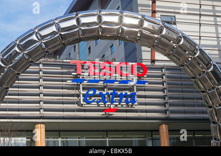 Tesco Extra sign seen through stainless steel Halo Sculpture, Gateshead, north east England UK Stock Photo