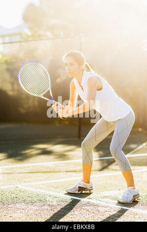USA, Florida, Jupiter, Portrait of young woman playing tennis in outdoor court Stock Photo