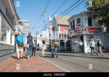 Street scene in Provincetown, Cape Cod, October 2014. Tourists and locals walk along Commerce street. Stock Photo