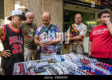 Men selling untaxed cigarettes on the streets of Naples. Stock Photo