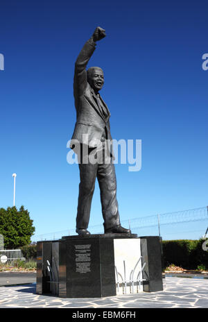 A statue of Nelson Mandela with his right arm raised in a black power salute. Stock Photo